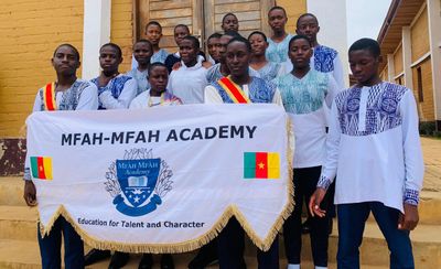 Students holding the school banner reading Education for Talent and Character